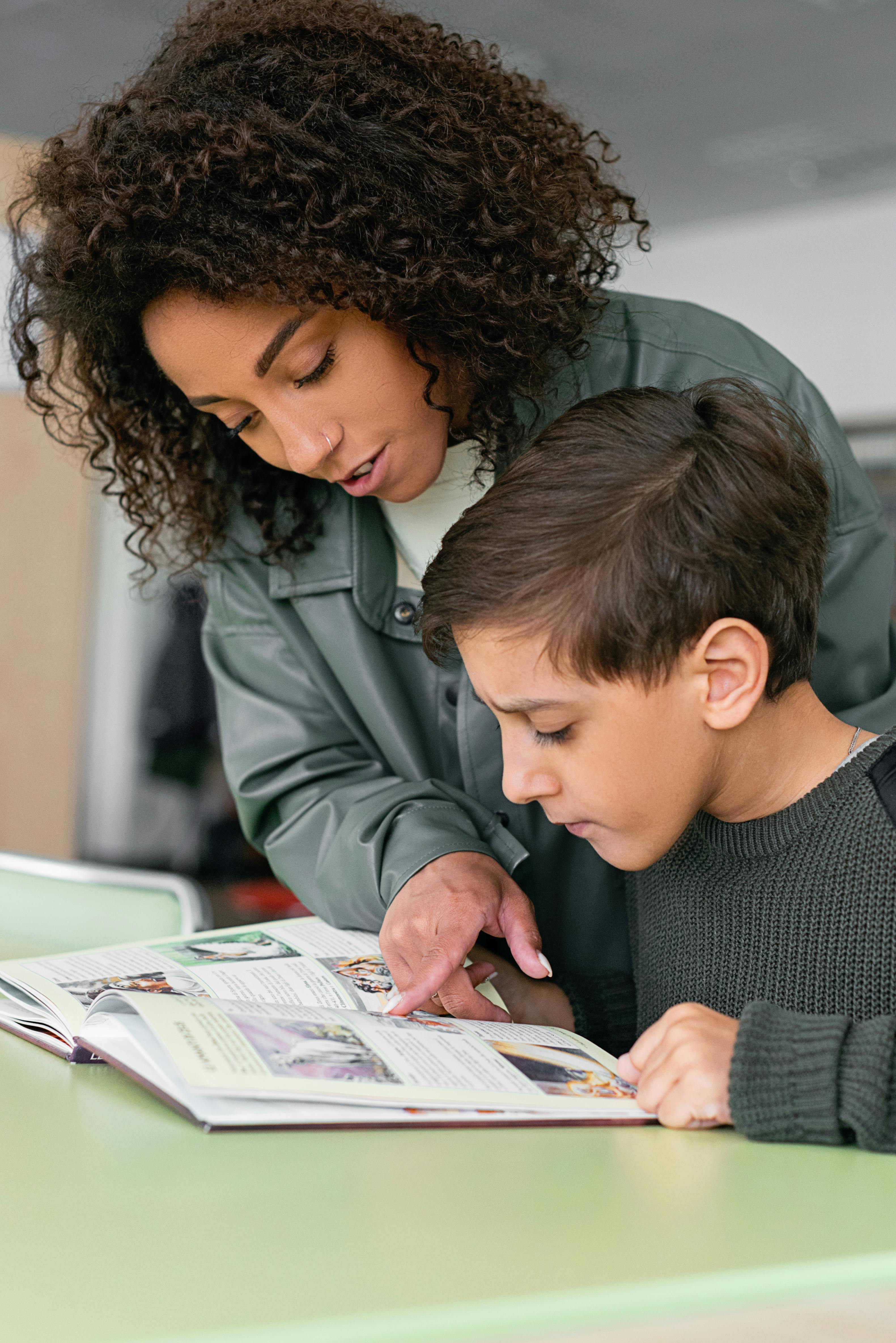 Educator assisting student in supportive academic environment