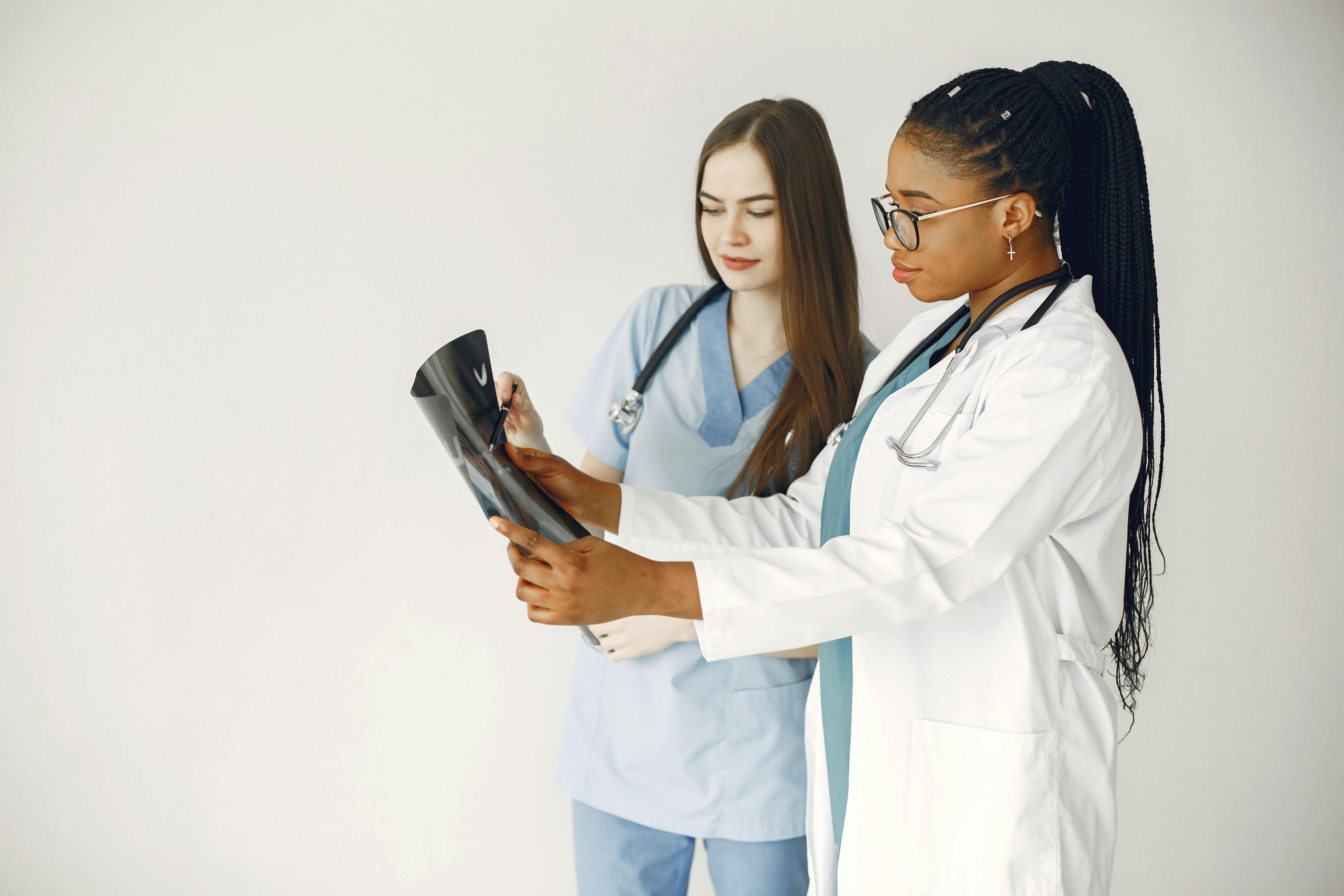 Healthcare professional speaking with patient in clinical consultation